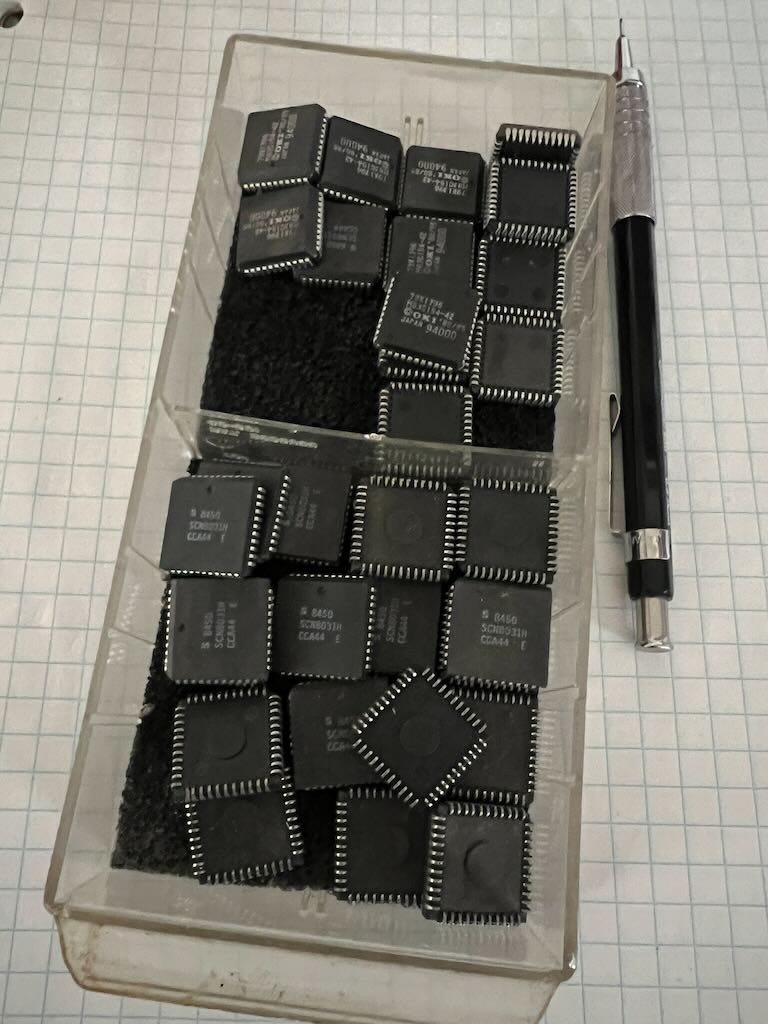 A drawer from one of the cabinets. It has two compartments, each filled with loads of 44-pin PLCC ICs
